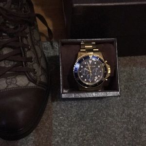 Michael Kors two tone gold, blue bezel watch.